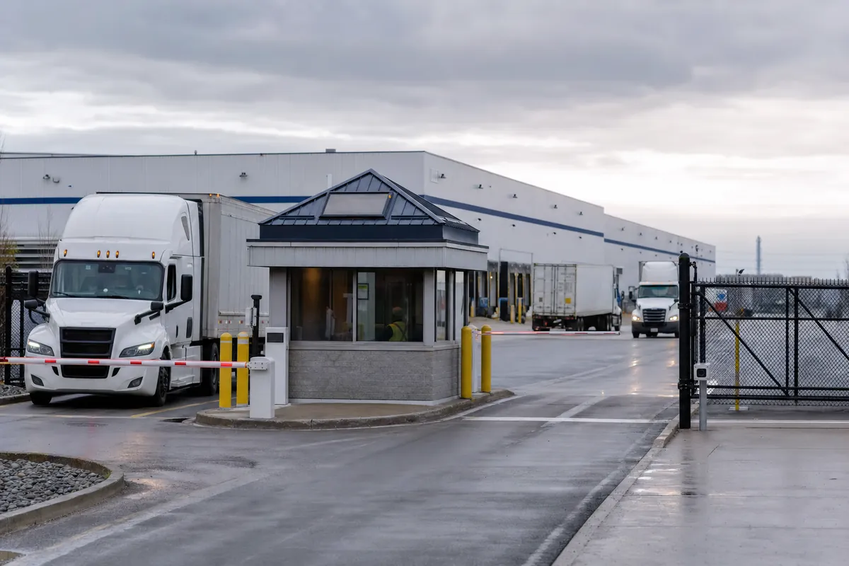 Controlled logistics yard entry with gatehouse and normal truck operations
